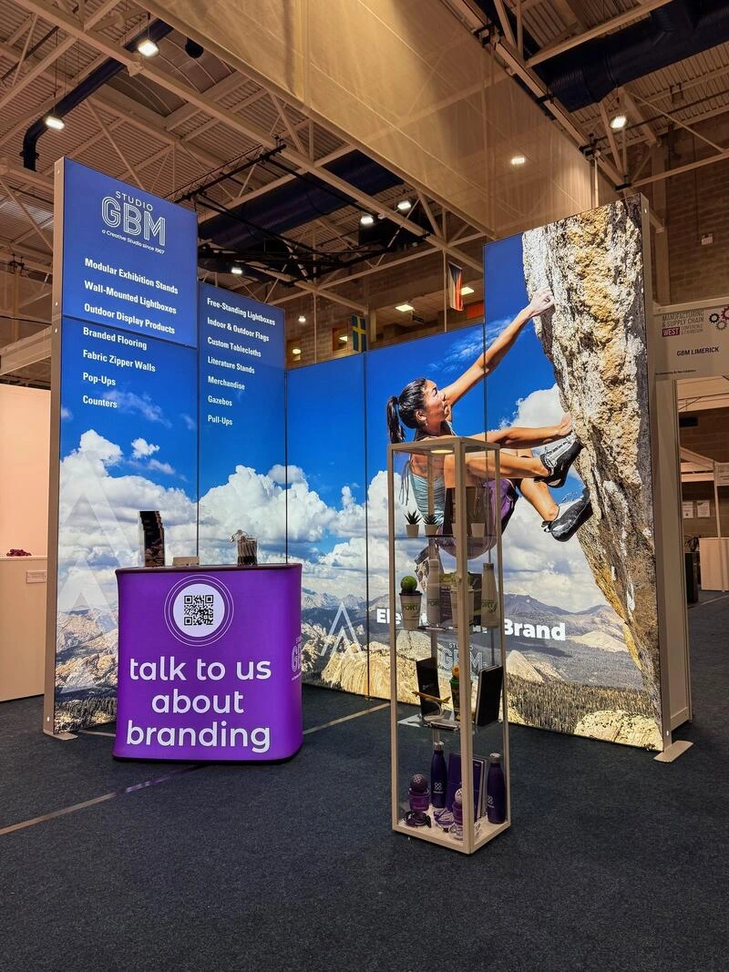 Wall-mounted lightbox display with branded graphics — Just Exhibit by Studio GBM